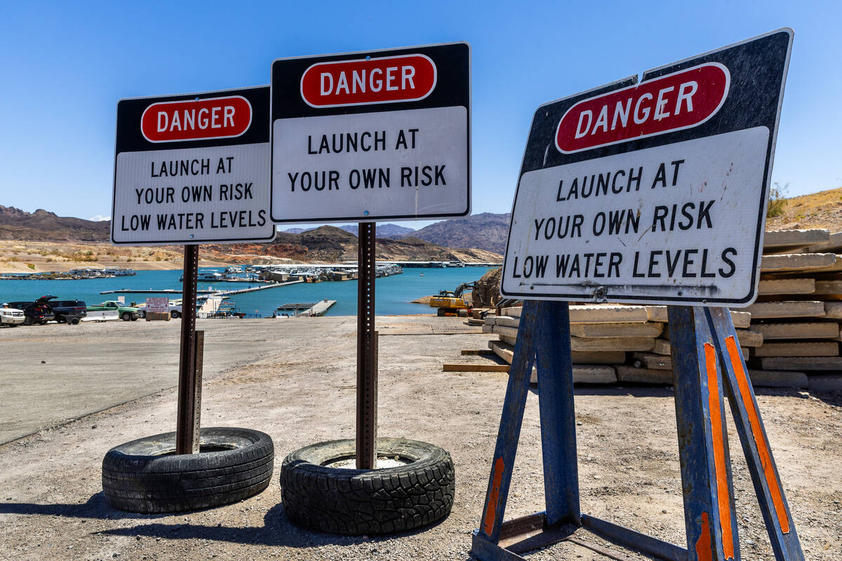 Signs caution launch risks due to low water levels at the Callville Bay Marina in the Lake Mead ...