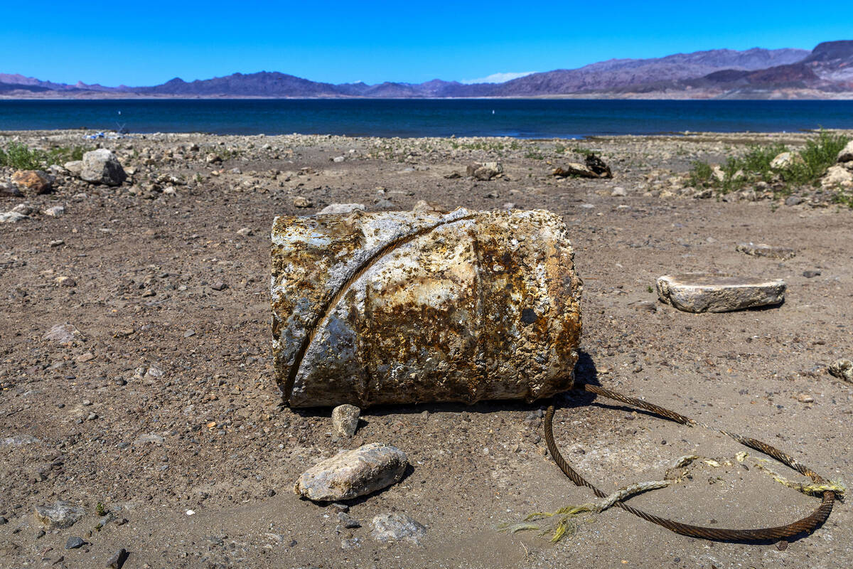 An old barrel sits exposed along Boulder Beach as the receding Lake Mead shoreline exposes new ...