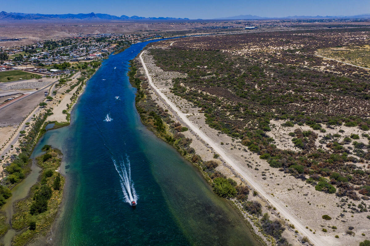 Boaters cruise along the Colorado River about Rotary Park on Friday, June 19, 2026, in Bullhead ...
