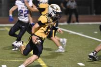 Robert Vendettoli/Boulder City Review Rushing upfield, Boulder City quarterback Logan Swint pic ...