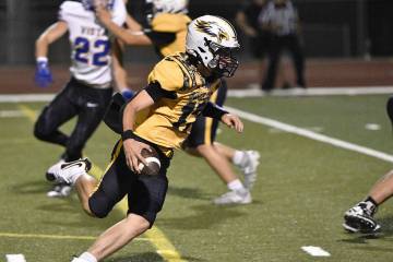 Robert Vendettoli/Boulder City Review Rushing upfield, Boulder City quarterback Logan Swint pic ...