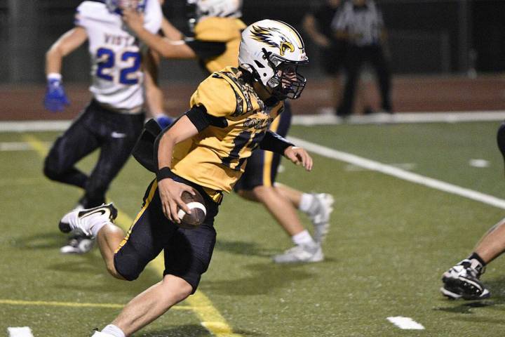 Robert Vendettoli/Boulder City Review Rushing upfield, Boulder City quarterback Logan Swint pic ...