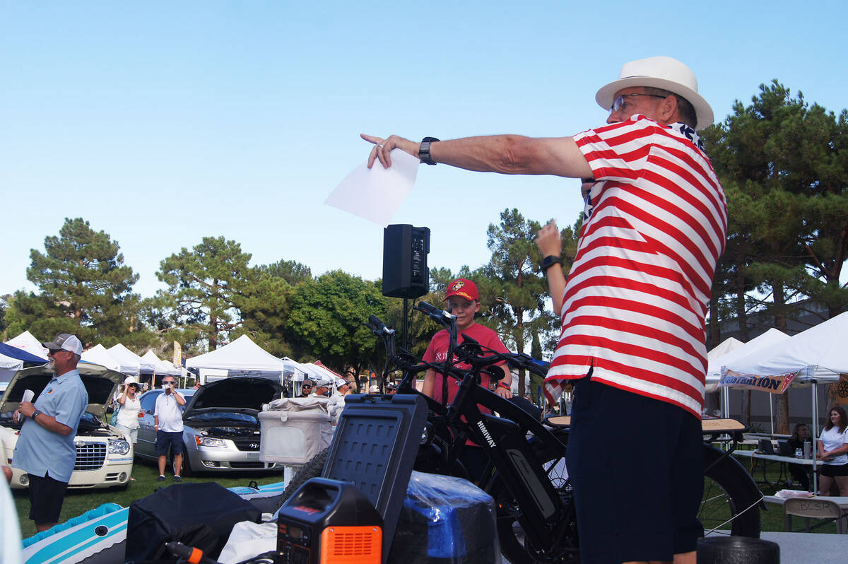 Photo courtesy Roger Hall Rotarian Eric Estes calls on a bidder during Wurst Fest’s popu ...