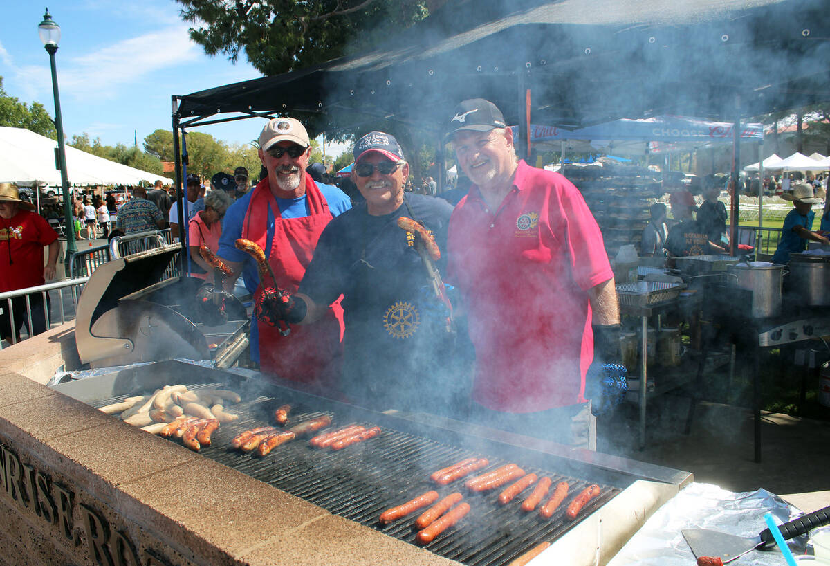 Ron Eland/Boulder City Review Looking through the smoke from the grill are (from left) Rotarian ...