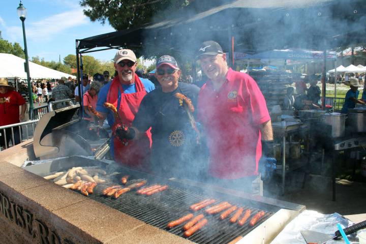 Ron Eland/Boulder City Review Looking through the smoke from the grill are (from left) Rotarian ...