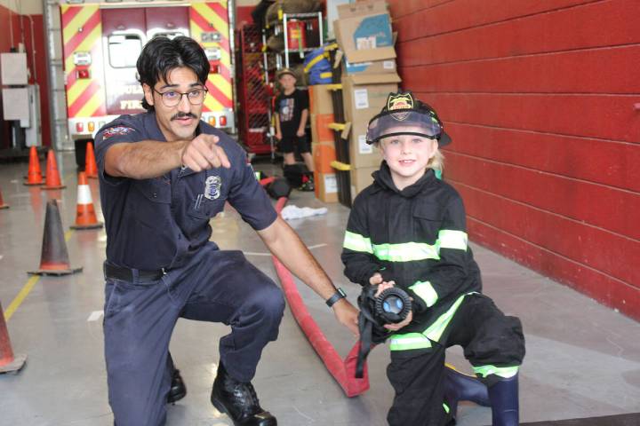 Ron Eland/Boulder City Review Boulder City Fire Department recruit Eric Benitez assists 7-year- ...